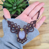 Handcrafted macramé necklace with a Rosa Quartz gemstone centerpiece and brass details, perfect as a gift from a small business for hippie, and wellbeing-focused clients.