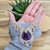 Handcrafted macramé necklace with an Amethyst gemstone centerpiece and brass details, perfect as a gift from a small business for hippie, spiritual, and wellbeing-focused clients.