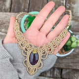 Handcrafted macramé necklace with an Amethyst gemstone centerpiece and brass details, perfect as a gift from a small business for hippie, and wellbeing-focused clients.