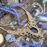 Handcrafted macramé necklace with an Amethyst gemstone centerpiece and brass details, perfect as a gift from a small business for hippie, and wellbeing-focused clients.