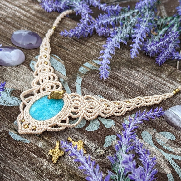 Handcrafted macramé necklace with an Amazonite gemstone centerpiece and brass details, perfect as a gift from a small business for hippie, and wellbeing-focused clients.