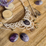 Handcrafted macramé necklace with an amethyst gemstone centerpiece and brass details, perfect as a gift from a small business for hippie, spiritual, and wellbeing-focused clients.