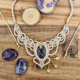 Handcrafted macramé necklace with an amethyst gemstone centerpiece and brass details, perfect as a gift from a small business for hippie, spiritual, and wellbeing-focused clients.