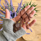 Handcrafted macramé pendant with a Rosa Quartz gemstone centerpiece and brass details, perfect as a gift from a small business for hippie, and wellbeing-focused clients.