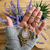 Handcrafted macramé pendant with a Rosa Quartz gemstone centerpiece and brass details, perfect as a gift from a small business for hippie, and wellbeing-focused clients.