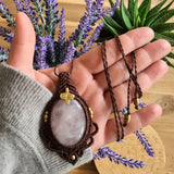 Handcrafted macramé pendant with a Rosa Quartz gemstone centerpiece and brass details, perfect as a gift from a small business for hippie, and wellbeing-focused clients.