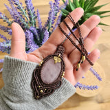 Handcrafted macramé pendant with a Rosa Quartz gemstone centerpiece and brass details, perfect as a gift from a small business for hippie, and wellbeing-focused clients.