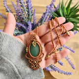 Handcrafted macramé pendant with an Aventurine gemstone centerpiece and brass details, perfect as a gift from a small business for hippie, and wellbeing-focused clients.