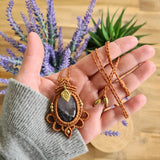 Handcrafted macramé pendant with an Amethyst gemstone centerpiece and brass details, perfect as a gift from a small business for hippie, and wellbeing-focused clients.