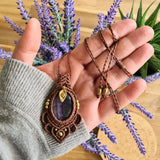 Handcrafted macramé pendant with an Amethyst gemstone centerpiece and brass details, perfect as a gift from a small business for hippie, and wellbeing-focused clients.