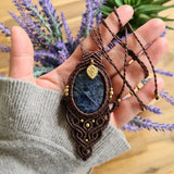 Handcrafted macramé pendant with a Sodalite gemstone centerpiece and brass details, perfect as a gift from a small business for hippie, and wellbeing-focused clients.