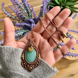 Handcrafted macramé pendant with an Aventurine gemstone centerpiece and brass details, perfect as a gift from a small business for hippie, and wellbeing-focused clients.