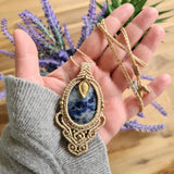 Handcrafted macramé pendant with a Sodalite gemstone centerpiece and brass details, perfect as a gift from a small business for hippie, and wellbeing-focused clients.