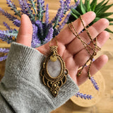 Handcrafted macramé pendant with a Rosa Quartz gemstone centerpiece and brass details, perfect as a gift from a small business for hippie, and wellbeing-focused clients.