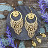 Handcrafted macramé earrings with brass details, perfect as a gift from a small business for hippie, and wellbeing-focused clients.