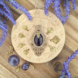 Handcrafted macramé pendant with an Amethyst gemstone centerpiece and brass details, perfect as a gift from a small business for hippie, and wellbeing-focused clients.