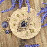 Handcrafted macramé pendant with an Amethyst gemstone centerpiece and brass details, perfect as a gift from a small business for hippie, and wellbeing-focused clients.