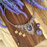 Handcrafted macramé necklace with an Amethyst gemstone centerpiece and brass details, perfect as a gift from a small business for hippie, spiritual, and wellbeing-focused clients.