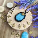 Handcrafted macramé pendant with an Amazonite gemstone centerpiece and brass details, perfect as a gift from a small business for hippie, and wellbeing-focused clients.