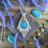 Handcrafted macramé pendant with an Amazonite gemstone centerpiece and brass details, perfect as a gift from a small business for hippie, and wellbeing-focused clients.