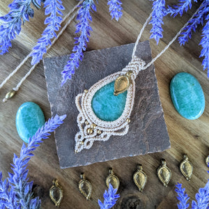 Handcrafted macramé pendant with an Amazonite gemstone centerpiece and brass details, perfect as a gift from a small business for hippie, and wellbeing-focused clients.