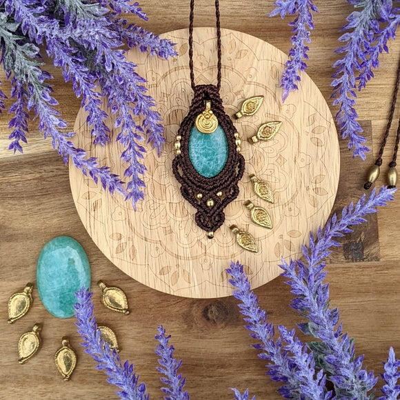 Handcrafted macramé pendant with an Amazonite gemstone centerpiece and brass details, perfect as a gift from a small business for hippie, and wellbeing-focused clients.