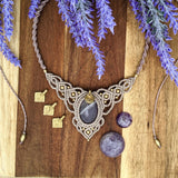 Handcrafted macramé necklace with an Amethyst gemstone centerpiece and brass details, perfect as a gift from a small business for hippie, spiritual, and wellbeing-focused clients.