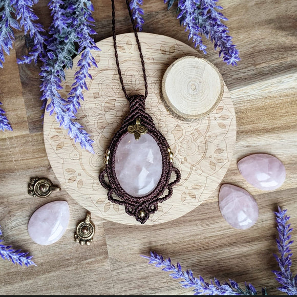 Handcrafted macramé pendant with a Rosa Quartz gemstone centerpiece and brass details, perfect as a gift from a small business for hippie, and wellbeing-focused clients.