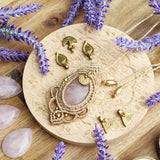 Handcrafted macramé pendant with a Rosa Quartz gemstone centerpiece and brass details, perfect as a gift from a small business for hippie, and wellbeing-focused clients.