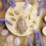 Handcrafted macramé pendant with a Rosa Quartz gemstone centerpiece and brass details, perfect as a gift from a small business for hippie, and wellbeing-focused clients.