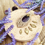 Handcrafted macramé pendant with an Amethyst gemstone centerpiece and brass details, perfect as a gift from a small business for hippie, and wellbeing-focused clients.