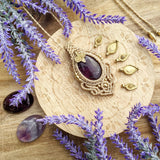 Handcrafted macramé pendant with an Amethyst gemstone centerpiece and brass details, perfect as a gift from a small business for hippie, and wellbeing-focused clients.