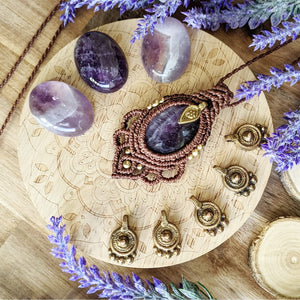 Handcrafted macramé pendant with an Amethyst gemstone centerpiece and brass details, perfect as a gift from a small business for hippie, and wellbeing-focused clients.