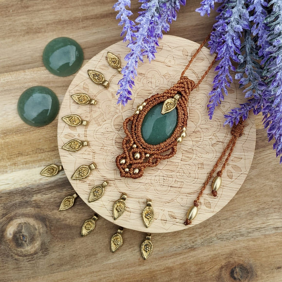 Handcrafted macramé pendant with an Aventurine gemstone centerpiece and brass details, perfect as a gift from a small business for hippie, and wellbeing-focused clients.