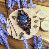 Handcrafted macramé pendant with a Sodalite gemstone centerpiece and brass details, perfect as a gift from a small business for hippie, and wellbeing-focused clients.