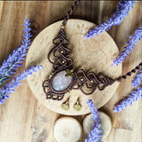 Handcrafted macramé necklace with a Rosa Quartz gemstone centerpiece and brass details, perfect as a gift from a small business for hippie, and wellbeing-focused clients.