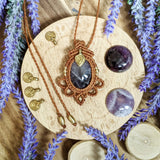 Handcrafted macramé pendant with an Amethyst gemstone centerpiece and brass details, perfect as a gift from a small business for hippie, and wellbeing-focused clients.