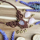 Handcrafted macramé necklace with a Rosa Quartz gemstone centerpiece and brass details, perfect as a gift from a small business for hippie, and wellbeing-focused clients.