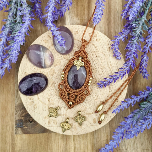 Handcrafted macramé pendant with an Amethyst gemstone centerpiece and brass details, perfect as a gift from a small business for hippie, and wellbeing-focused clients.