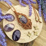 Handcrafted macramé pendant with an Amethyst gemstone centerpiece and brass details, perfect as a gift from a small business for hippie, and wellbeing-focused clients.