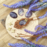 Handcrafted macramé pendant with an Amethyst gemstone centerpiece and brass details, perfect as a gift from a small business for hippie, and wellbeing-focused clients.