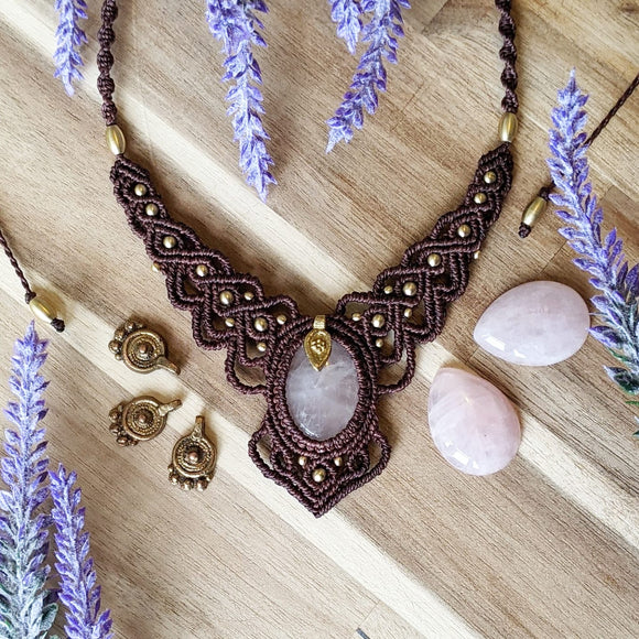 Handcrafted macramé necklace with a Rosa Quartz gemstone centerpiece and brass details, perfect as a gift from a small business for hippie, and wellbeing-focused clients.