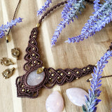 Handcrafted macramé necklace with a Rosa Quartz gemstone centerpiece and brass details, perfect as a gift from a small business for hippie, and wellbeing-focused clients.