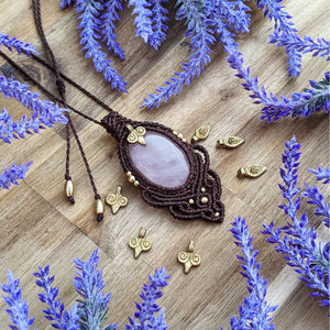 Handcrafted macramé pendant with a Rosa Quartz gemstone centerpiece and brass details, perfect as a gift from a small business for hippie, and wellbeing-focused clients.