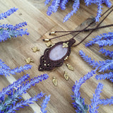 Handcrafted macramé pendant with a Rosa Quartz gemstone centerpiece and brass details, perfect as a gift from a small business for hippie, and wellbeing-focused clients.