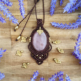 Handcrafted macramé pendant with a Rosa Quartz gemstone centerpiece and brass details, perfect as a gift from a small business for hippie, and wellbeing-focused clients.