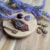 Handcrafted macramé pendant with an Amethyst gemstone centerpiece and brass details, perfect as a gift from a small business for hippie, and wellbeing-focused clients.