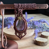 Handcrafted macramé pendant with an Amethyst gemstone centerpiece and brass details, perfect as a gift from a small business for hippie, and wellbeing-focused clients.