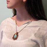 Handcrafted macramé pendant with an Aventurine gemstone centerpiece and brass details, perfect as a gift from a small business for hippie, and wellbeing-focused clients.