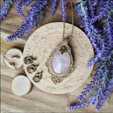 Handcrafted macramé pendant with a Rosa Quartz gemstone centerpiece and brass details, perfect as a gift from a small business for hippie, and wellbeing-focused clients.